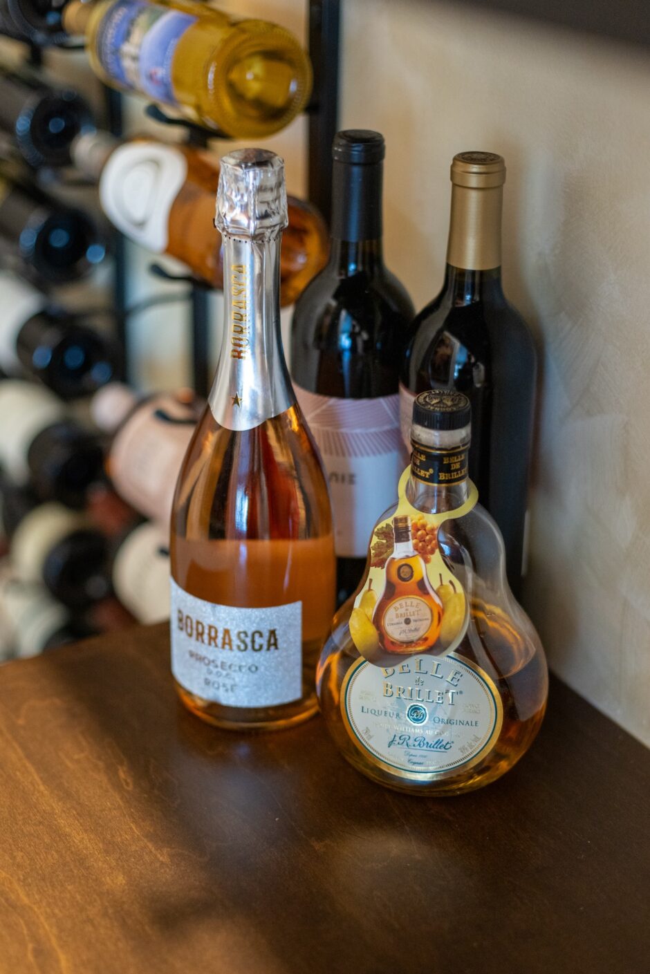 Liquor Bottles Sitting On Wood Sideboard